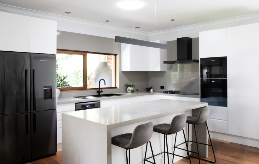 A beautiful kitchen remodel with grey / off white quartz countertops, overlay quartz countertops in a amazing modern kitchen remodel